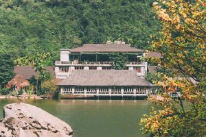 a large building sitting on top of a body of water at Thung Nham Resort in Ninh Binh