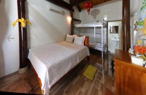 a bedroom with a large bed and a bathroom at Cornflower Homestay PHONG NHA in Phong Nha