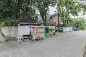 a small vehicle parked on the side of a street at RedDoorz near RS Sari Asih Ciledug in Jakarta