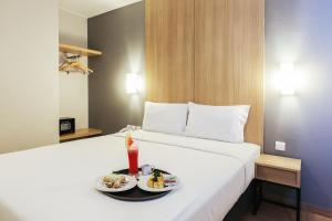 Postel nebo postele na pokoji v ubytování Hotel Citradream Tugu Yogyakarta