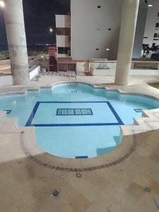 a large swimming pool in a building at night at Apartamento mar in Cartagena de Indias