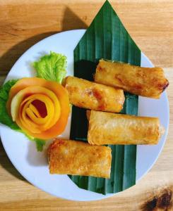 a white plate with some food on a table at Cu Chi Boutique Farmstay in Ho Chi Minh City