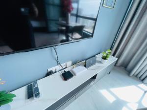 a white desk in a room with a large mirror at Jesselton Quay HOMESTAY by Stanton Homes in Kota Kinabalu