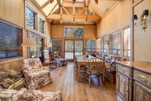 a living room with a table and chairs and windows at Close to the Lake, Peaceful 5 Bedroom #343 in Tamarack