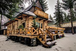 a log cabin on a truck in the snow at ZAKOPIANA Domek in Zakopane