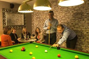 a man playing a game of pool in a bar at North Kessock Hotel in Inverness