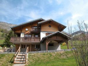 a large wooden house with a balcony on a hill at Chalet Abondance, 7 pièces, 14 personnes - FR-1-692-5 in Abondance
