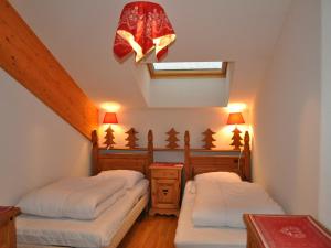 a attic bedroom with two beds and a skylight at Appartement La Chapelle-d'Abondance, 3 pièces, 6 personnes - FR-1-692-15 in La Chapelle-dʼAbondance