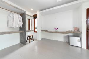 a room with white walls and white tile floors and a white refrigerator at Ibiza Bungalows in Haad Yao +123 photos