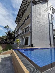 an image of a swimming pool in front of a house at Y Villa Residencies in Galle