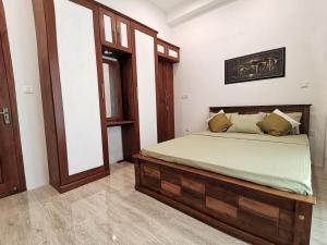 a bedroom with a bed and a large mirror at Y Villa Residencies in Galle
