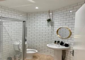 een badkamer met een toilet, een wastafel en een spiegel bij Mollyinn Central Brighton in Brighton & Hove