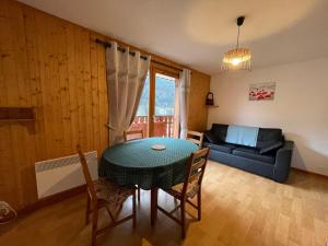 a living room with a table and a couch at Appartement La Chapelle-d'Abondance, 2 pièces, 5 personnes - FR-1-692-35 in La Chapelle-dʼAbondance