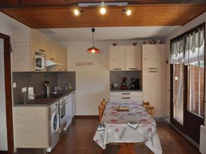 a kitchen with a table and a kitchen with a sink and a stove at Charmant 3 pièces au cœur d’Abondance avec Multi Pass à 3€/jour/personne – Parking et balcon ouest - FR-1-692-62 in Abondance +3 photos