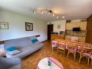 a living room with a couch and a table and a kitchen at Appartement La Chapelle-d'Abondance, 2 pièces, 6 personnes - FR-1-692-23 in La Chapelle-dʼAbondance