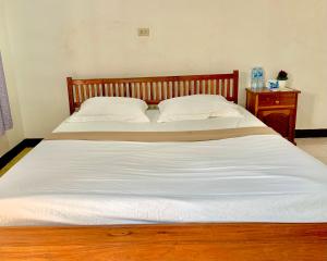 Postel nebo postele na pokoji v ubytování Nakasang Paradise Hotel