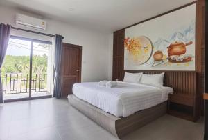 Postel nebo postele na pokoji v ubytování โรงแรมชลาลัย กระบี่ Chalalai Hotel Krabi