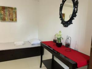 a room with a table and a mirror on the wall at Batis ni Juan Leisureland in Dipaculao