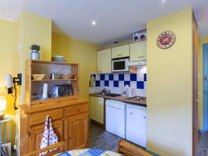 a small kitchen with a sink and a counter at Appartement Cauterets, 3 pièces, 5 personnes - FR-1-401-248 in Cauterets