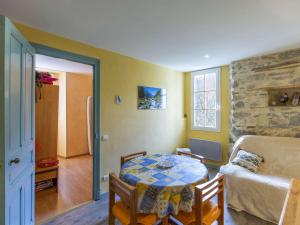 a living room with a table and a couch at Appartement Cauterets, 3 pièces, 5 personnes - FR-1-401-248 in Cauterets