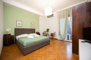 a bedroom with a bed and a large window at L'Imperiale RomaTrastevere in Rome