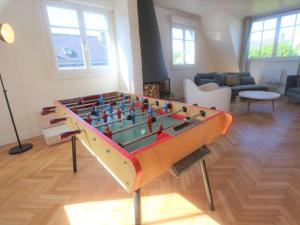 a living room with a large foosball table at Grande Maison Rénovée 3* à Bénodet, Jardin Clos, Salle de Jeux, Parking, Wifi, Terrasse, 4 chambres - FR-1-481-112 in Bénodet
