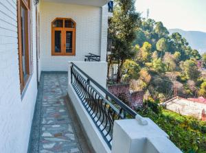 a balcony of a house with a window at Three bedroom house with private garden in Solan