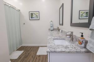 a white bathroom with a sink and a shower at Brand new home minutes to Sandpoint and Schweitzer in Ponderay