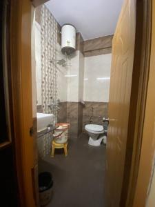 a bathroom with a toilet and a sink at DS Residency in Varanasi