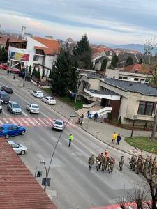 un grupo de soldados en una calle de la ciudad con coches en Apartament Carolina Parc en Alba Iulia