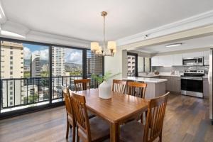 a kitchen and dining room with a large window at Expansive Lanai w/ Panoramic Views - Walk to Waikiki Beach in Honolulu