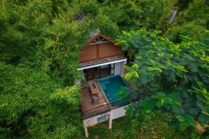 an overhead view of a tree house in the forest at Morickap Resort in Vythiri