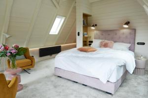 a bedroom with a large bed in a attic at Five Rooms in Leer