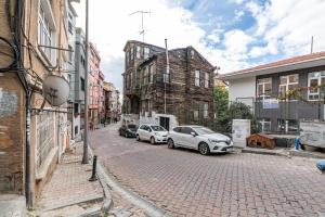 two cars parked on a brick street with buildings at Your peaceful home with a unique Hagia Sophia view in Istanbul