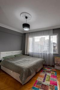 a bedroom with a bed and a large window at Your peaceful home with a unique Hagia Sophia view in Istanbul