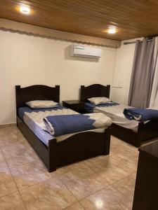 two beds are in a room with at MiaDa’bia in Madaba
