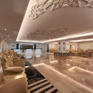 a lobby with couches and chairs in a building at Puteri Wing - Riverside Majestic Hotel in Kuching