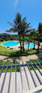 a view of a swimming pool and palm trees at Pebble Beach 242 in Umhlanga