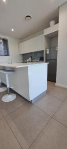 a kitchen with a white counter and a refrigerator at Pebble Beach 242 in Umhlanga