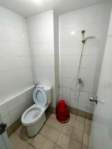 a small bathroom with a toilet and a shower at Toptravel Bassura City in Jakarta