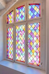 a window with stained glass in a room at Hôtel Le Mondon in Metz