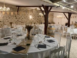 a dining room with white tables and white chairs at Château Marith - Etablissement climatisé avec Piscine in Clairac