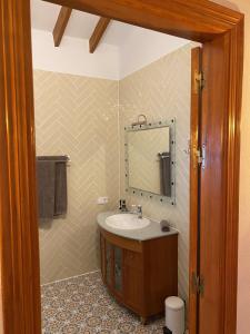 a bathroom with a sink and a mirror at Panoramavilla Lofio Spain in Cómpeta