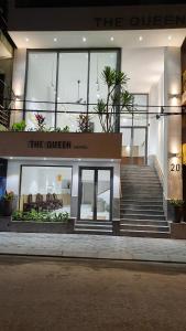 a store front with stairs in front of a building at The Queen Hotel Ninh Binh in Ninh Binh