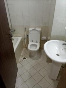 a bathroom with a toilet and a sink at عجمان in Ajman 