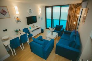an overhead view of a living room with blue furniture at Come a Lot Aparthotel Batumi in Batumi