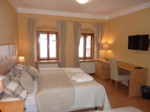 Posteľ alebo postele v izbe v ubytovaní Apartments and Suites Kremnica