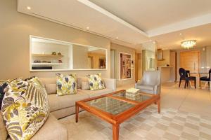 a living room with a couch and a coffee table at Luxury Villa in V&A Waterfront in Cape Town