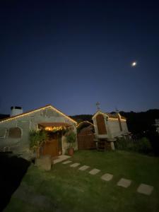 a house with lights on the side of it at night at Casa Rural A Gorgoriña in Cangas de Morrazo