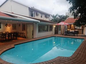 a large swimming pool in front of a house at Africatamna Self Catering House in Durban
